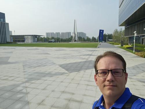 Christian standing in front of the DKU Phase II campus in August 2023.